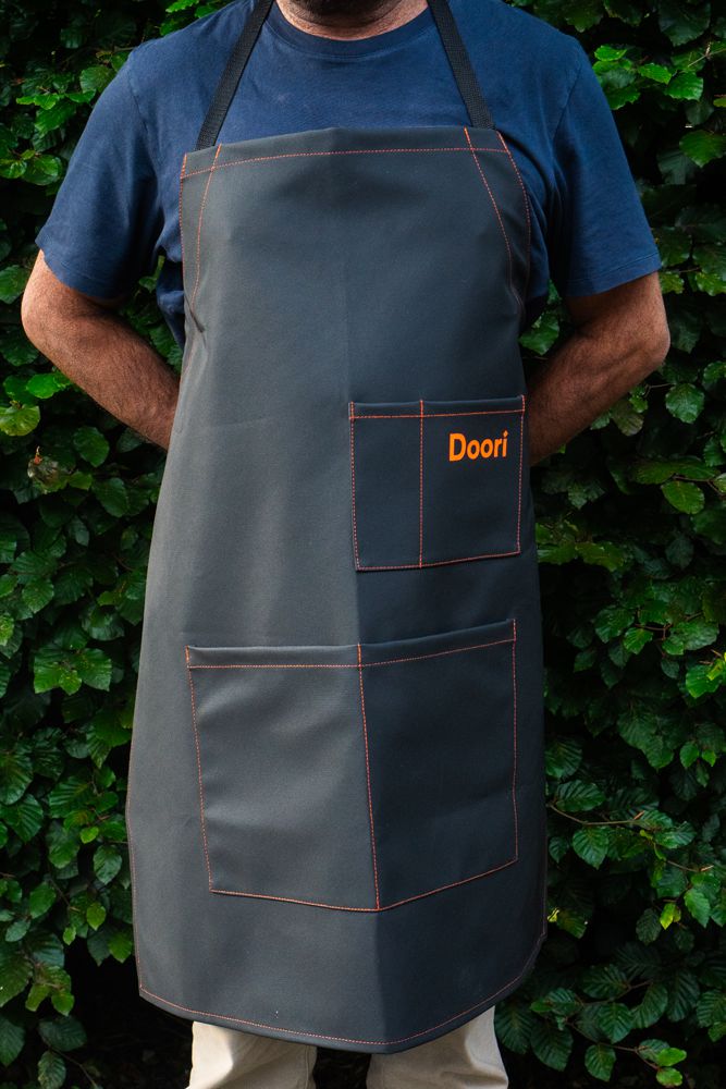 A man wearing the Doori Cooking Apron.